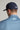 A person wearing a golf cap in navy colour, size fitted