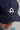 A person wearing a golf cap in navy colour, size fitted