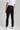 A person wearing golf trousers with stretch, in black