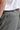A person wearing a belt with a tri-colour design