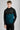 A person wearing a golf hoodie with a 1/4 zip in green and black