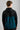 A person wearing a golf hoodie with a 1/4 zip in green and black