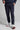 A man wearing navy stretch blue golf trousers