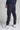 A man wearing navy stretch blue golf trousers