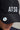 A man wearing a golf cap in black, featuring a ball marker