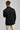 A person wearing a jacket in black with quilted baffle upper panels