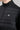 A person wearing a jacket in black with quilted baffle upper panels