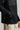 A person wearing a jacket in black with quilted baffle upper panels
