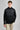 A person wearing a jacket in black with quilted baffle upper panels