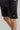 A person wearing sweat shorts in black
