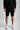 A person wearing sweat shorts in black