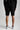 A person wearing sweat shorts in black