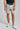 A person wearing golf shorts in grey