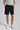 A person wearing golf shorts in black