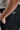 A person wearing golf shorts in black