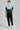 A person wearing a golf polo in green and mint
