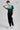 A person wearing a golf polo in green and mint