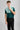 A person wearing a golf polo in green and mint