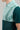 A person wearing a golf polo in green and mint