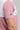A person wearing a golf polo in white and pink