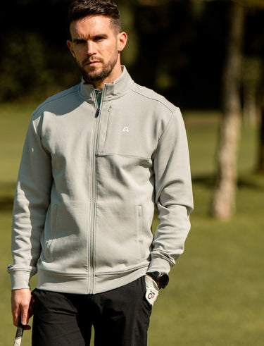 Man wearing a jacket in grey on a golf course