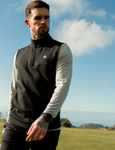 Man wearing a golf gilet in black on a golf course
