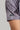 A person wearing a golf polo with grey Vapor Geo Print