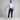 Man in golf attire holding a golf club on a plain background