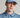 A person wearing a golf cap in blue, size fitted