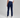 Person wearing navy pants and white sneakers on a gray background