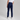 Person wearing navy pants and white sneakers on a gray background