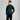 Man wearing a black and teal tracksuit on a gray background