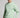 A man wearing a crew neck sweatshirt in green