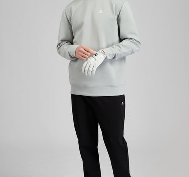 A man wearing a crew neck sweatshirt in grey
