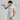 Man in gray golf outfit holding a golf club against a light gray background