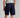 Person wearing navy shorts on a plain background