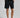 A person wearing golf shorts in black