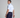 Man in golf attire holding a golf club on a plain background