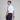Man in golf attire holding a golf club on a plain background