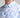 Close-up of a person wearing a light blue and white patterned shirt.