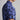 Blue camouflage-patterned shirt with a brand logo on a gray background