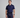 Man wearing a navy blue golf outfit with a white background
