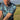 Video of male golfer in a blue floral polo shirt
