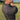 Man swinging a golf club in black polo shirt