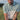 Golfer swinging in a green and white two tone golf polo shirt